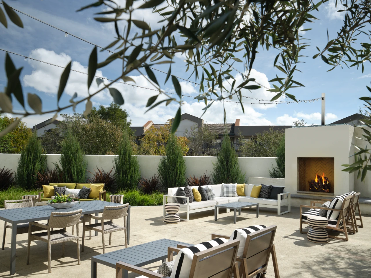 Exterior patio at The Knoll with seating and outdoor fireplace.